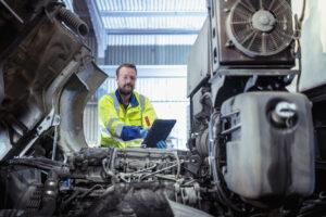 A man ticking off a checklist for urgent shipping repairs