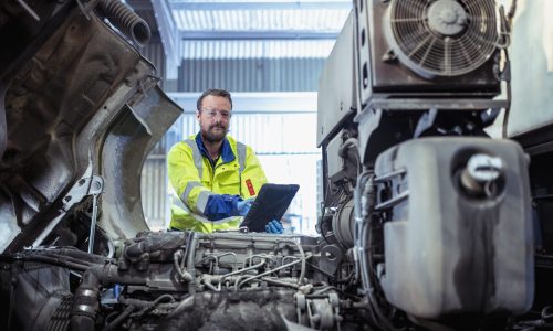 A man ticking off a checklist for urgent shipping repairs